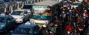 Cars, buses and motorcycles sit in congested traffic in the business district in Jakarta.