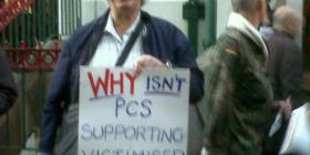 Former PCS rep with a placard reading 'why won't PCS support victimised reps?'