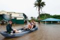  Keara,Lacey and Erich Stewart paddle in a kayak after flood waters entered there back yard on March 30, 2017 in ...