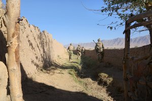 File - Georgian troops are shown the hidden spots Taliban use to shoot rockets at Bagram Air Field during a foot patrol threw the village of Kalamusa on Bagram, Afghanistan, Oct. 11, 2014.