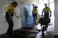 Workers clean up Clarke Creek State School after the deluge following Cyclone Debbie.