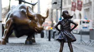 In this March 22, 2017 photo, the Charging Bull and Fearless Girl statues are shown on Lower Broadway in New York.