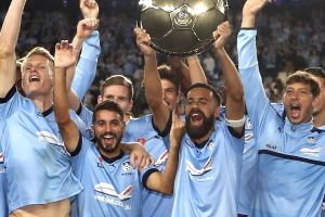 Winners are grinners: Sydney FC players celebrate with the Premiers Plate.