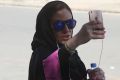 Saudi activist Ghada Ghazzawi tapes a selfie video marking a historical day for Saudi women as she arrives to vote for ...