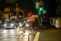 A meal delivery rider on Crown Street in Surry Hills makes a dash through red lights.