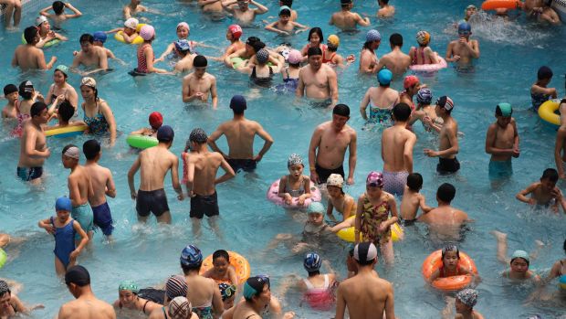 North Koreans spend their holiday weekend at the indoor swimming pool of Munsu water park on Sunday, April 16, 2017, in ...