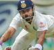 MELBOURNE, AUSTRALIA - DECEMBER 30: Virat Kohli of India dives to make his ground as Nathan Lyon of Australia misses a ...