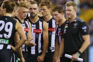 Disappointed: Coach Nathan Buckley with his players at Etihad Stadium.