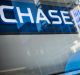 Signage is reflected in the window of a JPMorgan Chase & Co bank branch in New York.