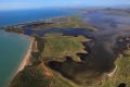 A picture of the Abbot Point coal loading facility showing coal water run-off moving north-west into the wetlands and ...