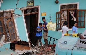 People affected by a garbage dump collapse salvage their belongings in Meetotamulla, on the outskirts of Colombo, Sri Lanka