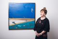 Artist Jinx Nolan with one of her abstracted landscapes on show in Sydney.