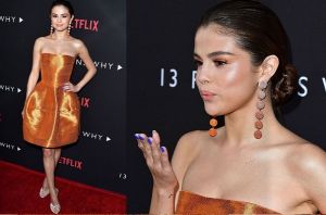 Selena Gomez looks shiny yet stylish in this orange Oscar de la Renta cocktail dress. It's very pretty and all, but it's ...