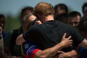 U.S. Invictus team member Ivan Castro hugs Prince Harry at the Invictus games in Orlando, Florida May 9, 2016