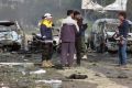 Rebel gunmen at the site of a blast that damaged several buses and vans.