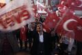 Residents wave 'Yes' and Turkish national flags outside of the AK Party headquarters in Istanbul, Turkey's largest city, ...