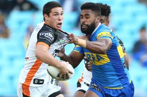 Collared: Tigers five-eighth Mitch Moses jostles with Michael Jennings on Monday.