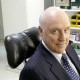 John Clarke sitting in a make up artist's chair at the ABC