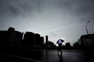 MELBOURNE, AUSTRALIA - APRIL 09: Weather in Victoria. A man is pictured crossing La Trobe St on April 9, 2017 in ...