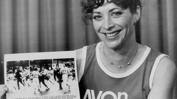 Switzer, pictured in 1983 holding a series of photographs depicting an official attempting to force her from the course ...