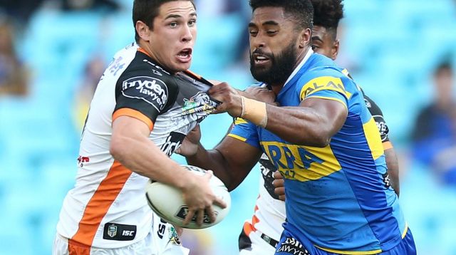 Collared: Tigers five-eighth Mitch Moses jostles with Michael Jennings on Monday.