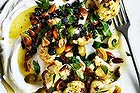 Warm salad of roast cauliflower, labne, olives and almonds.