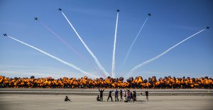 The Patriots Jet Team performs aerial acrobatics as pyrotechnics provided by the Tora Bomb Squad of the Commemorative Air Force explode, forming a "Wall Of Fire" during the 2017 Yuma Airshow at Marine Corps Air Station Yuma, Ariz., Saturday, March 18, 2017.