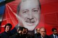 Supporters of the "Yes" campaign stand in front of a giant picture of Turkish President Recep Tayyip Erdogan.