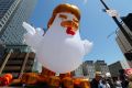 A giant inflatable "Chicken Don" is set up by demonstrators in downtown Los Angeles.