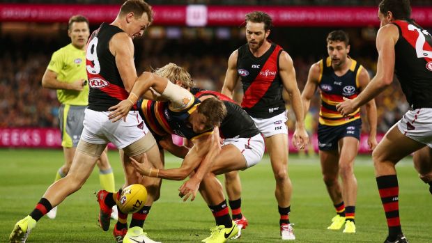 Crow sandwich: Matt Crouch is tackled by Brendon Goddard (left) and Darcy Parish.