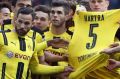 Tribute: Dortmund players hold the jersey of injured teammate Marc Bartra at the weekend.