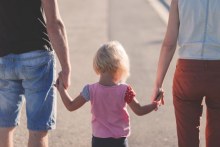 Family walking hand in hand (ABC News)