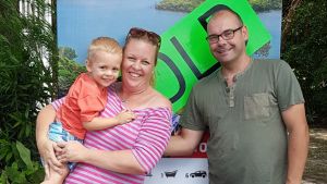 Monique Kinerson with her partner and child, outside the house they bought with cash.