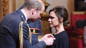 Fashion designer Victoria Beckham, right, receives her OBE from Britain's Prince William, the Duke of Cambridge during ...