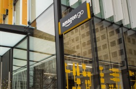 Pedestrians walk past the new Amazon.com grocery store in Seattle, Washington.