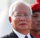 Malaysian Prime Minister Najib Razak, left, and Malaysia Inspector General Police Khalid Abu Bakar, right, inspect a ...