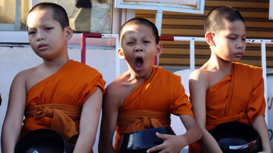 One of novice Buddhist monks yawns during a merit in Bangkok, Thailand, Wednesday, April 19, 2017. Thai men are expected ...