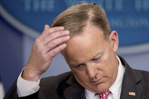 White House press secretary Sean Spicer brushes a fly off his head as he talks to the media during the daily press briefing at the White House in Washington, Monday, April 17, 2017.