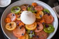 Burrata and heirloom tomato salad with baby herbs at Comida.