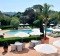 The hotel was once a private villa and still feels like one, surrounded by olive trees and lawns, and reflected in a ...