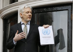 Wikileaks founder Julian Assange. holding a U.N. report speaks on the balcony of the Ecuadorean Embassy in London, Friday, Feb. 5, 2016.