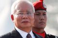 Malaysian Prime Minister Najib Razak, left, and Malaysia Inspector General Police Khalid Abu Bakar, right, inspect a ...