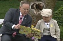 Sean Spicer reading How to Catch the Easter Bunny with the help of a young volunteer. 