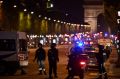 Police officers secure the area after a gunman opened fire on Champs Elysees.