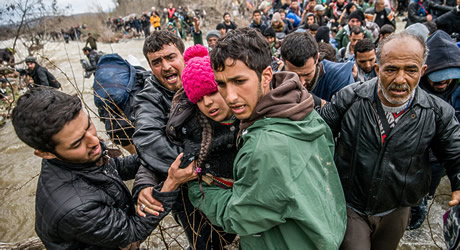  Hundreds of migrants blocked by closure of the Greek-Macedonian border cross a river near Idomeni village in northern Greece on an alternate route to pass the border between Greece and the Former Yugoslav Republic of Macedonia. 14 March 2016.  EPA/ZOLTAN