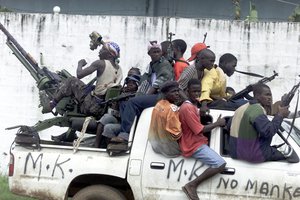 File - Rebels soldiers patrol in their area of occupation in Monrovia, Liberia, Friday, Aug. 8, 2003 during the savage civil war.