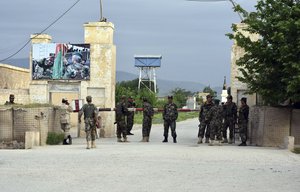 Afghan soldiers stand guard at the gate of a military compound after an attack by gunmen in Mazar-e- Sharif province north of kabul, Afghanistan, Friday, April 21, 2017.