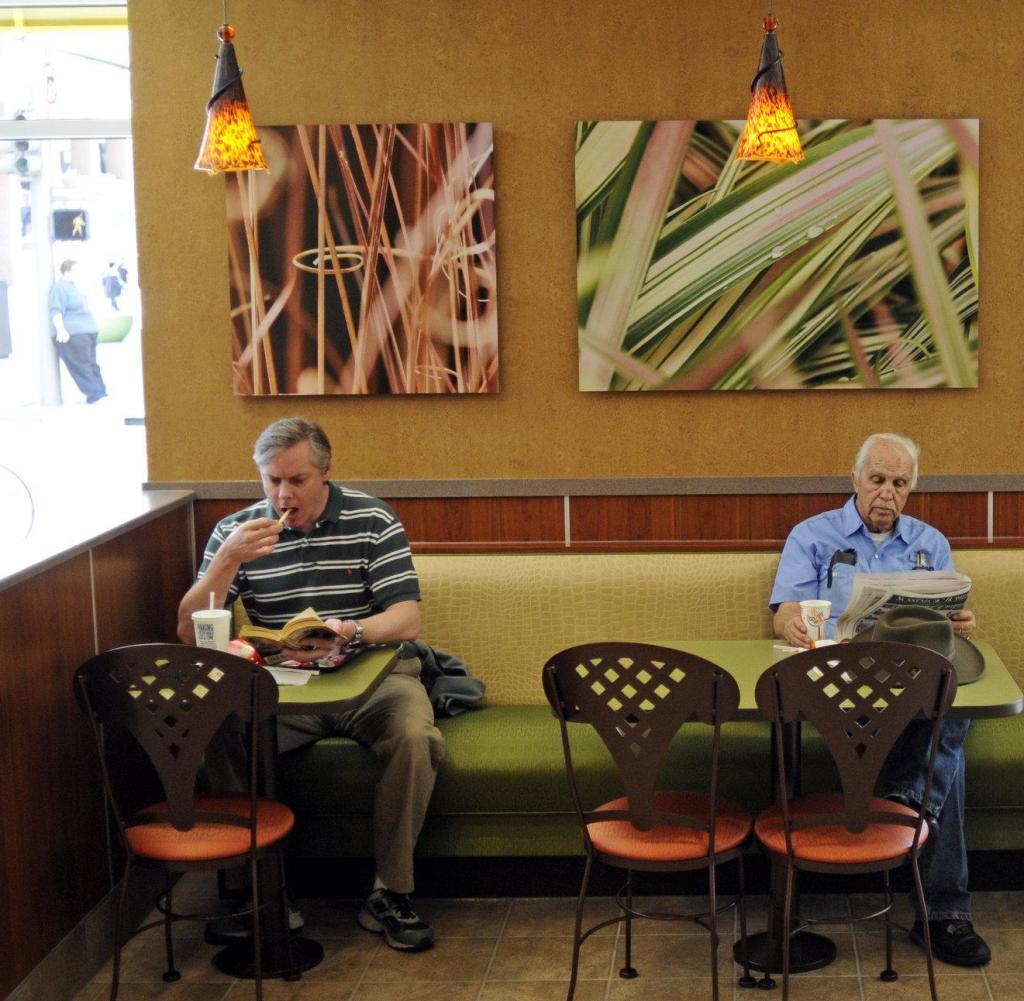 (JS) MCDONALDS24--From left, Michael Hess, Less Jones, and Pat King eat lunch in the McDonald's at 16th Street/Cleveland Place that has undergone a major makeover that has given it a hip coffee shop vibe. Hess said, "it looks like it should be in Aspen."