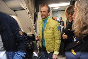 Italy's Michele Scarponi smiles as he boards the flight transferring Giro d' Italia, Tour of Italy cyclists, from Dublin, Ireland, to Bari, Italy, Monday, May 12, 2014.