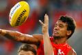 Small win: Callum Ah Chee of the Suns tries to punch the ball clear of Adelaide's Rory Laird.